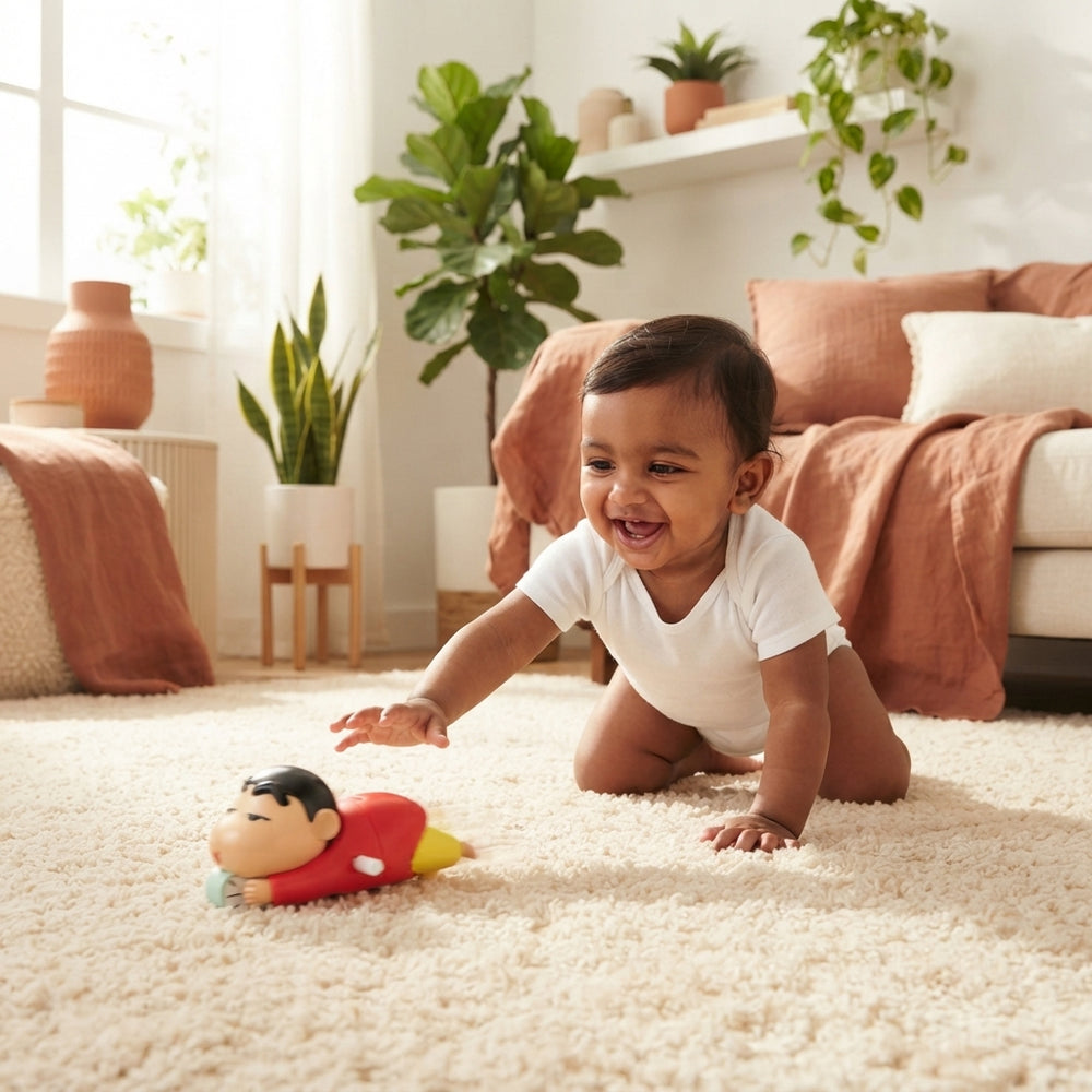 A South Asian baby crawling on a cream-colored rug while reaching for a Shinchan crawling toy in a sunlit living room.